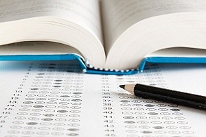 Image of a book and a standardized test representing special education advocates
