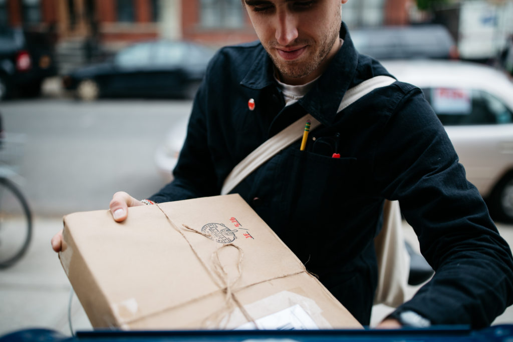 Man receiving a package containing his hard-earned Certificate of Completion